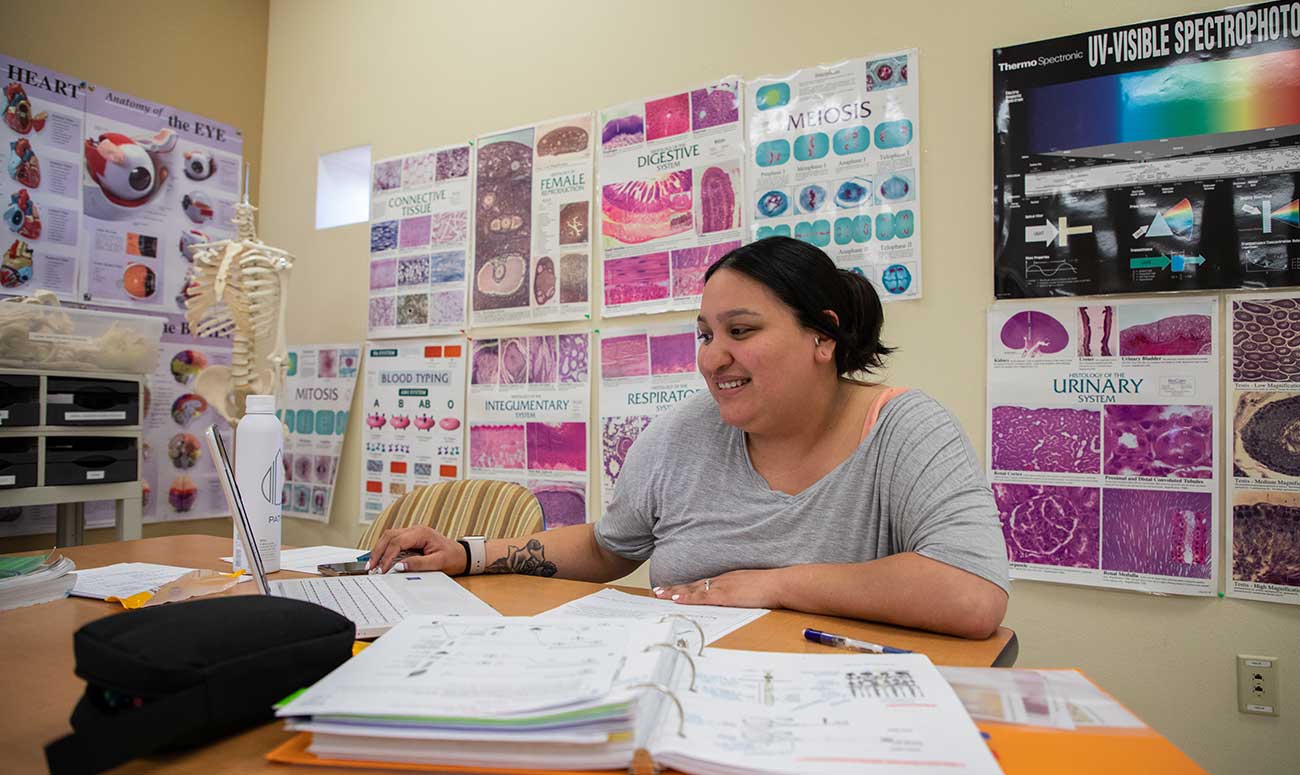 A student studies in the tutoring center in Raymond Hall Library.