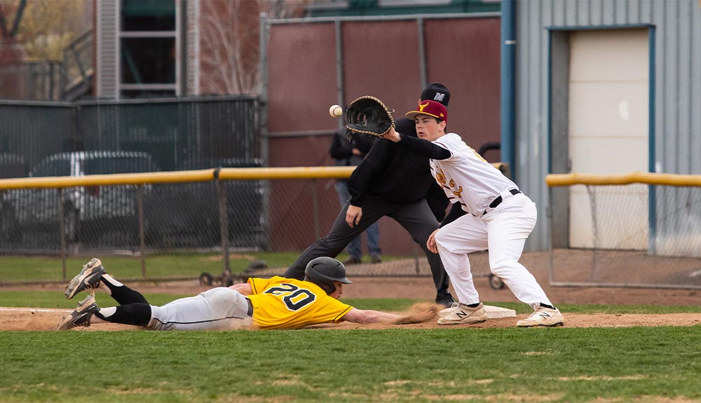 Baseball player slides for first base