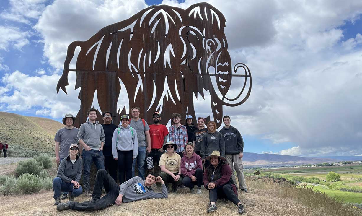 Geology students in front of mammoth statue