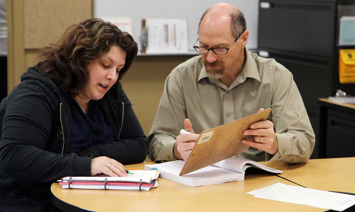 Lewis works with a student in YVC's Math Center.