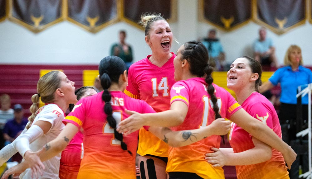 Volleyball player Mckenna Steiner celebrates with teammates