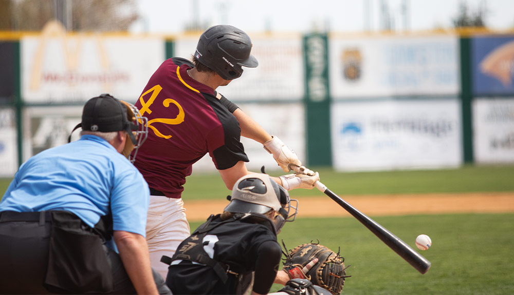 Yakima Valley College baseball player at bat makes contact with pitch