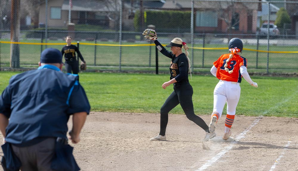 Yakima Valley College softball infielder gets opponent out at first base