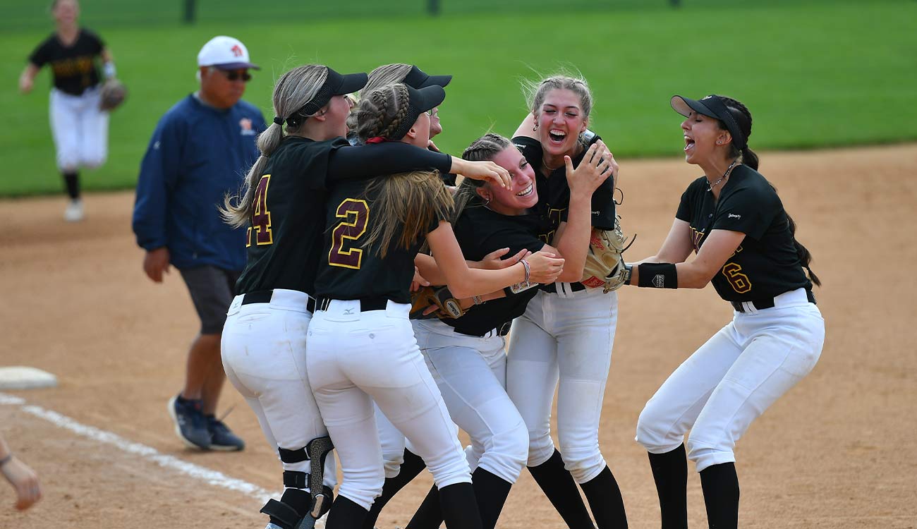 Yak softball players celebrate win. 