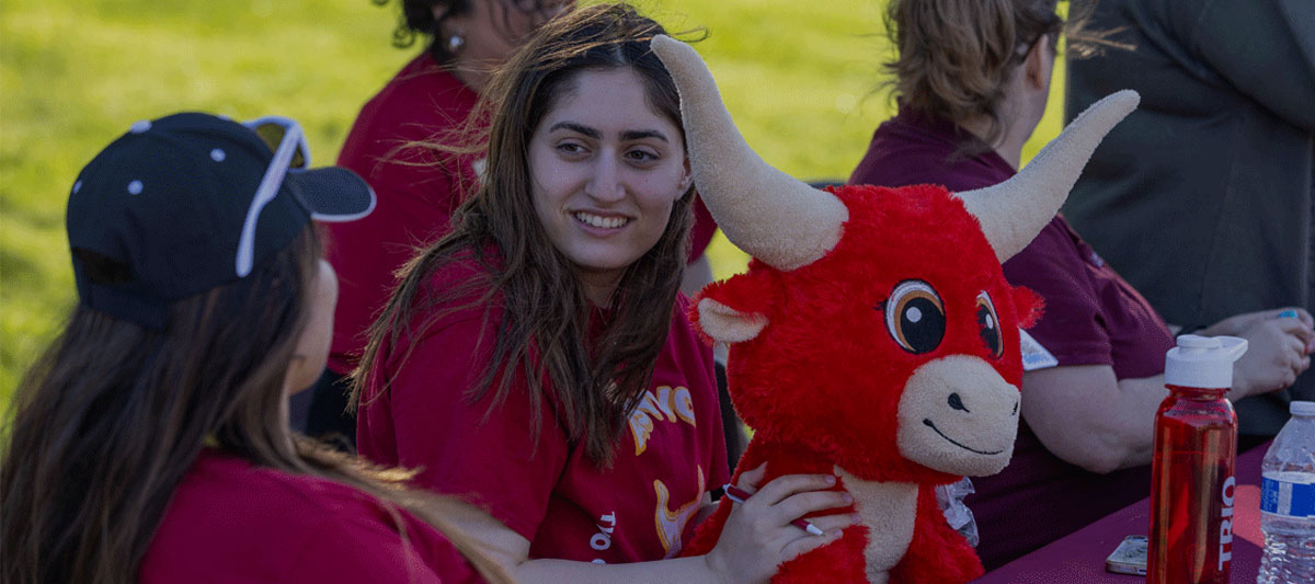 Two students wearing their YVC shirts have a conversation on the YVC campus during Yak Nights. 