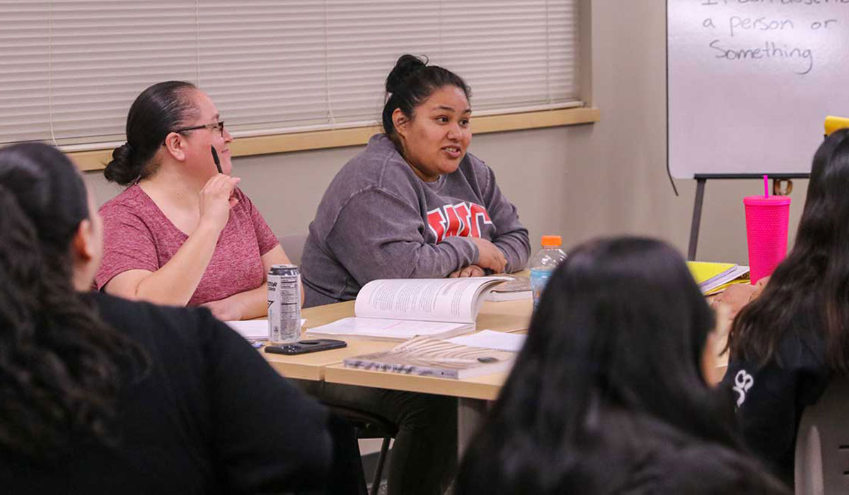 Students work on a group project in their class for the BASM program