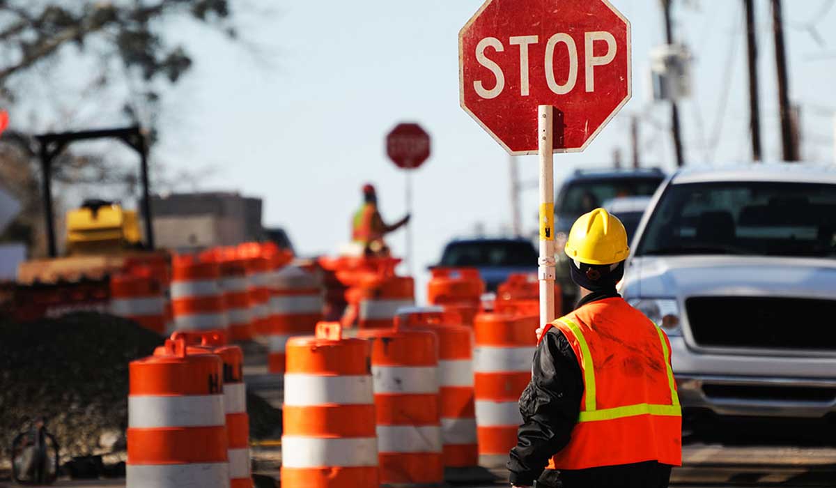 Flaggers holding a stop sign