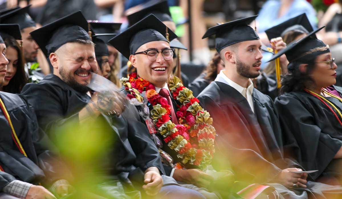 Students smiling at commencement ceremony