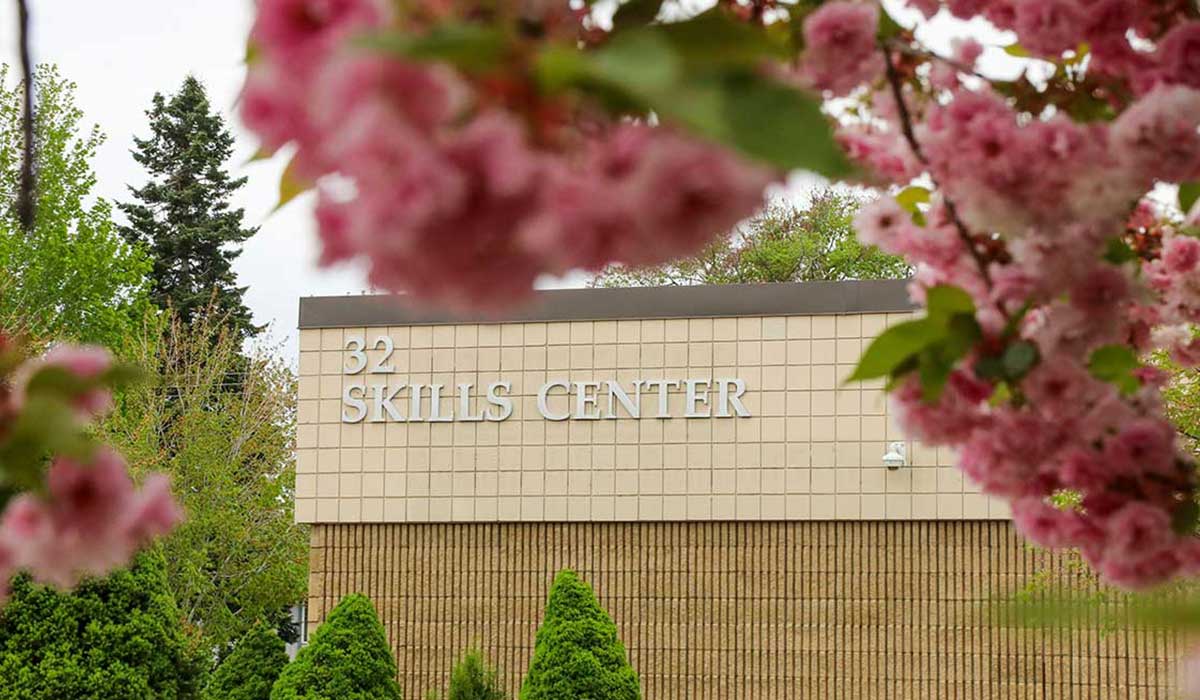 Skills Center building with flowers in foreground