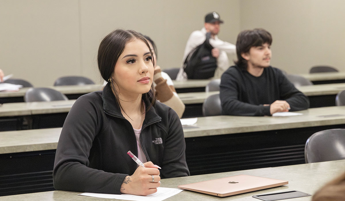 Business student in class listening to a lecture