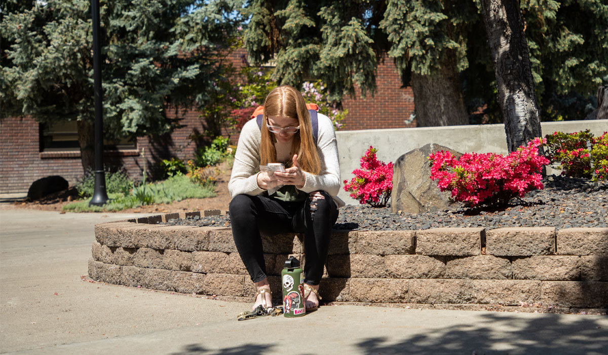 Student sits outside between classes. 