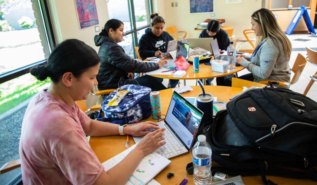 Students work on lap tops between classes. 