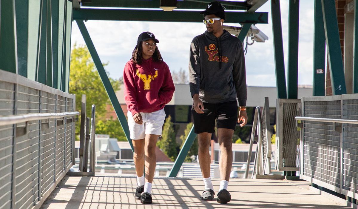 Students walk over the bridge at the Yakima Campus. 