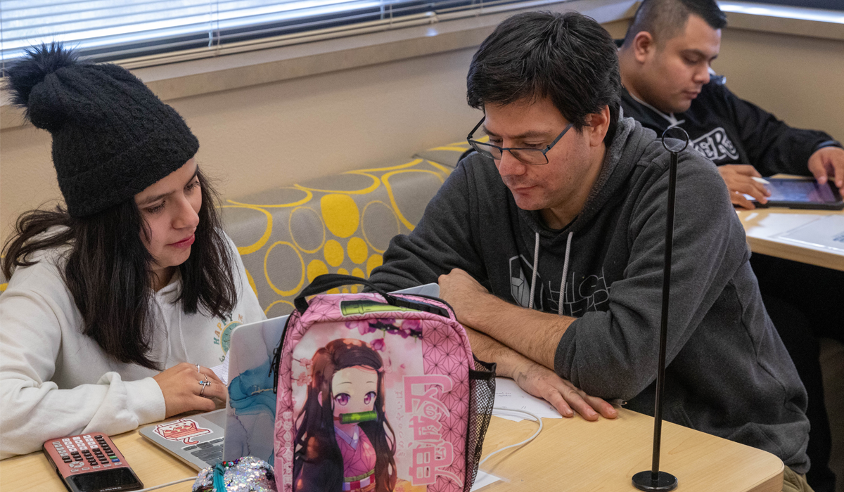 Faculty member assisting student with an assignment.