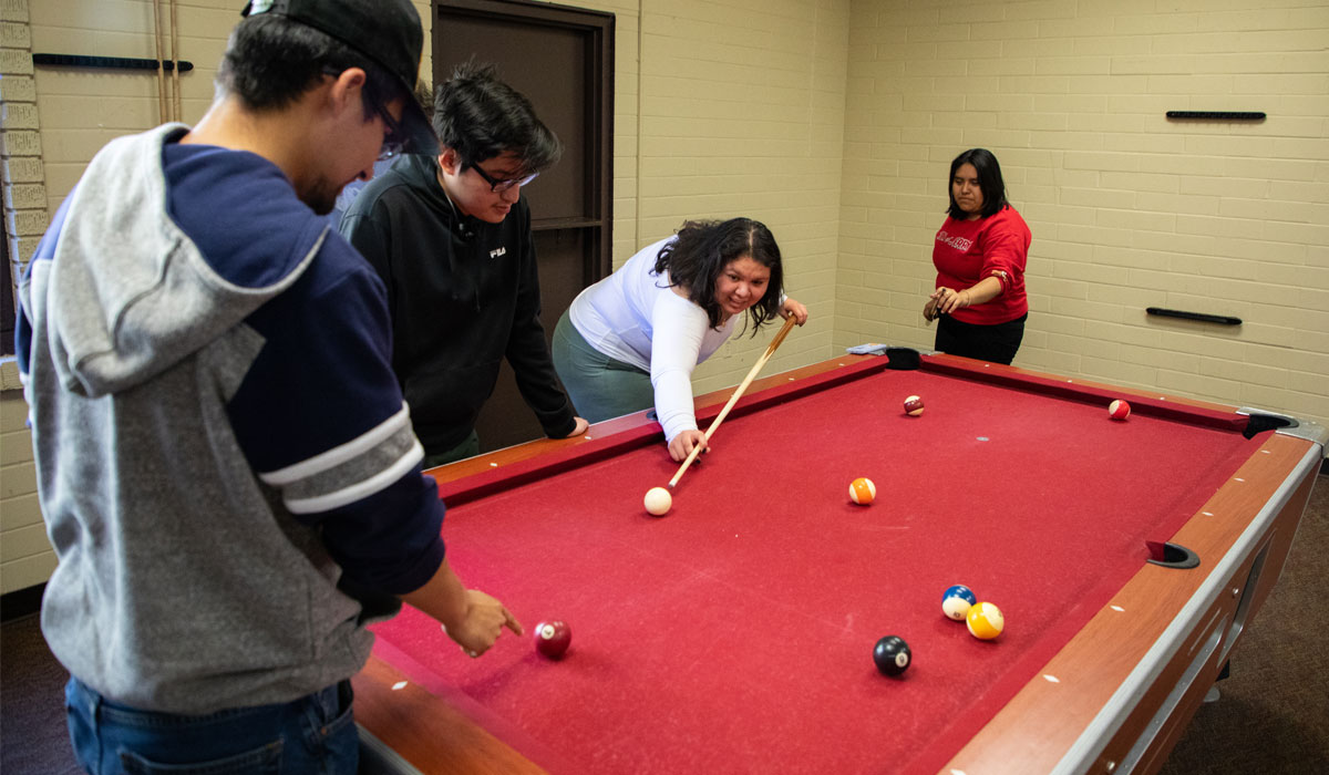 YVC students playing pool in a YVC residence.