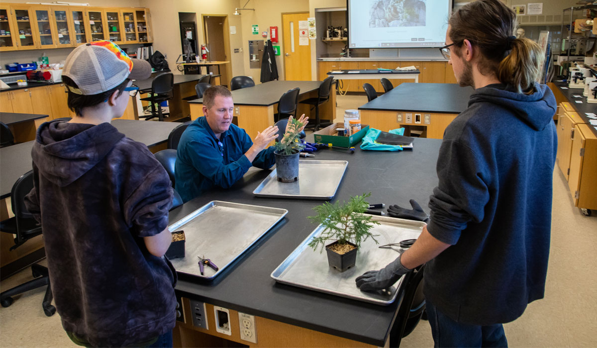 Students planting during classroom assignment.