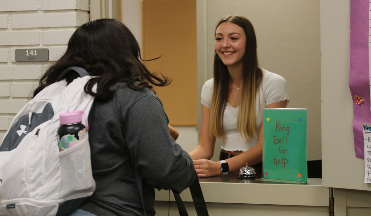 Two students speak between classes.