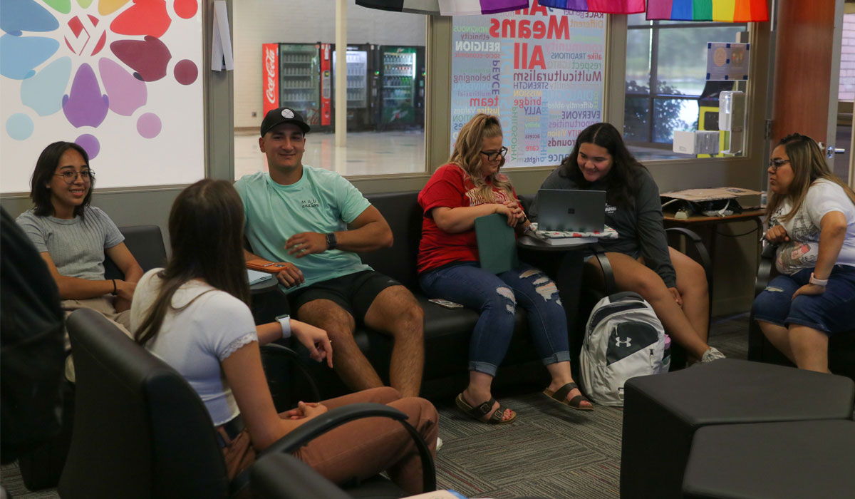 Students sitting around talking in a YVC common area.