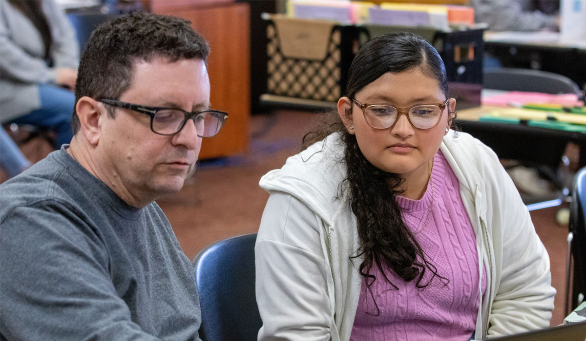 YVC Employee instructs student at a computer.