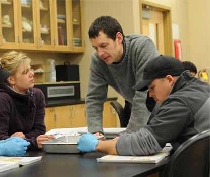 Matthew Loeser works with students during a class on the YVC campus. 