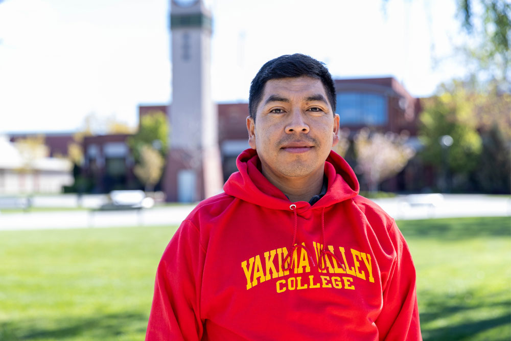 Horacio Hernandez pictured on YVC campus with clock tower in the background. 