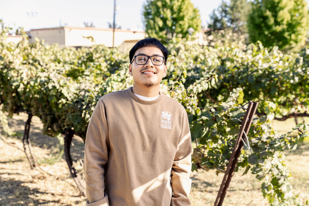 Luis Lopez poses for profile picture in local vineyard. 