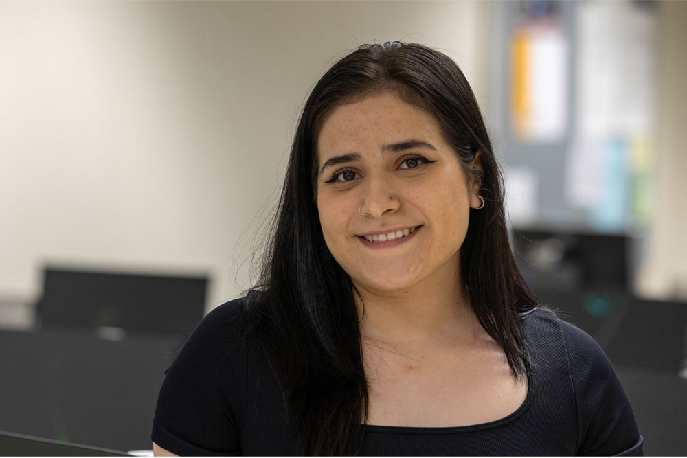 Martha Olivera pictured in front of a Computer Lab. 