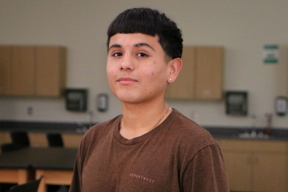 Angel Gonzalez poses for Student Story picture in a YVC classroom. 