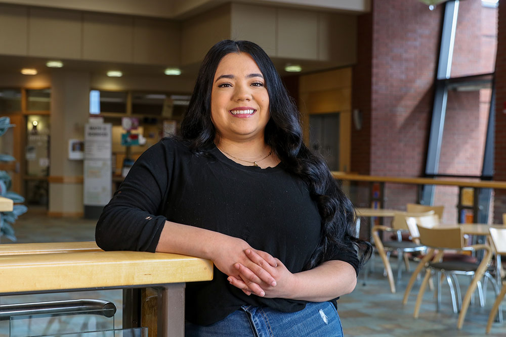 Darlene Mendoza poses for Student Story picture in a YVC common area. 