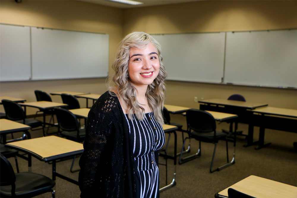 Lucero Liliana Mendez poses for Student Story picture in a YVC classroom. 