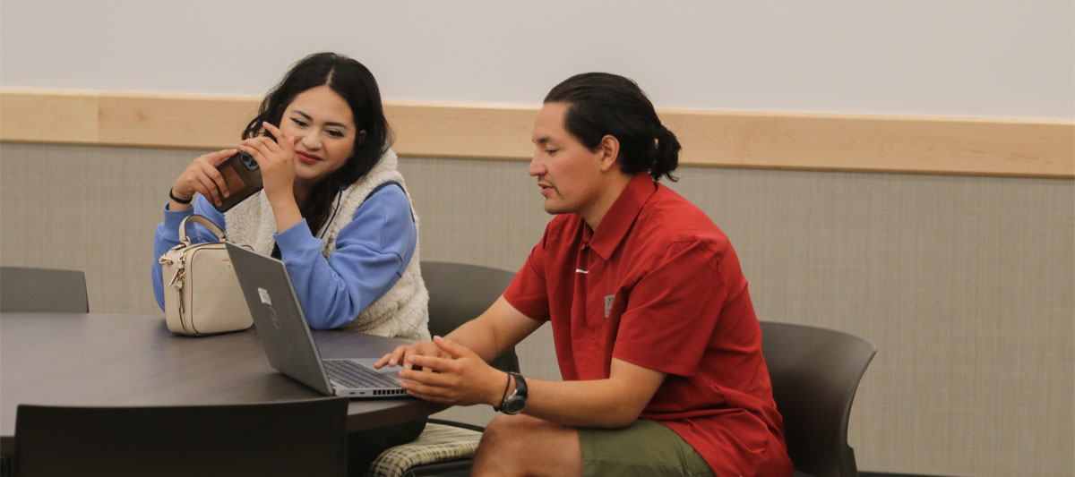 Faculty member assisting student during workshop. 