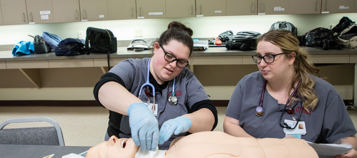 Two YVC nursing students working on handson project during nursing class. 