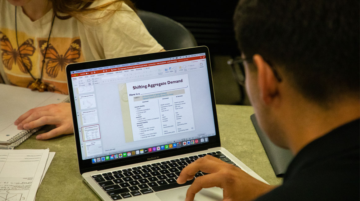 Student completes assignment using lap top. 