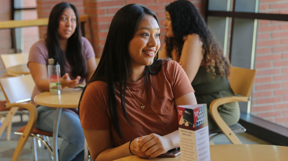 Student sits at table between classes. 